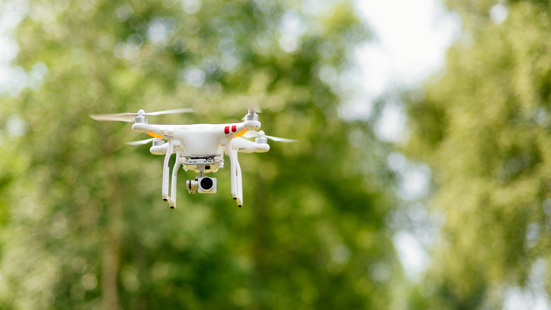 DJI professional camera drone flying high in the air