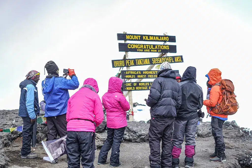 Group of hikers at the summit of Mount Kilimanjaro Tanzania.jpg