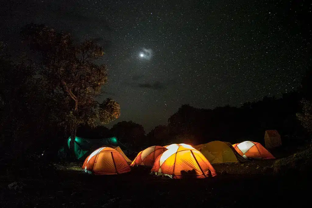 Tents are pitched under the night sky on Mount Kilimanjaro Tanzania.jpg