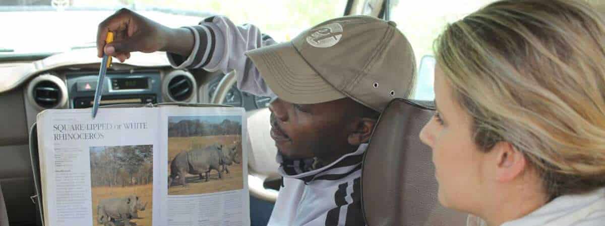 Tanzania - safari guide explanation to traveller - posts