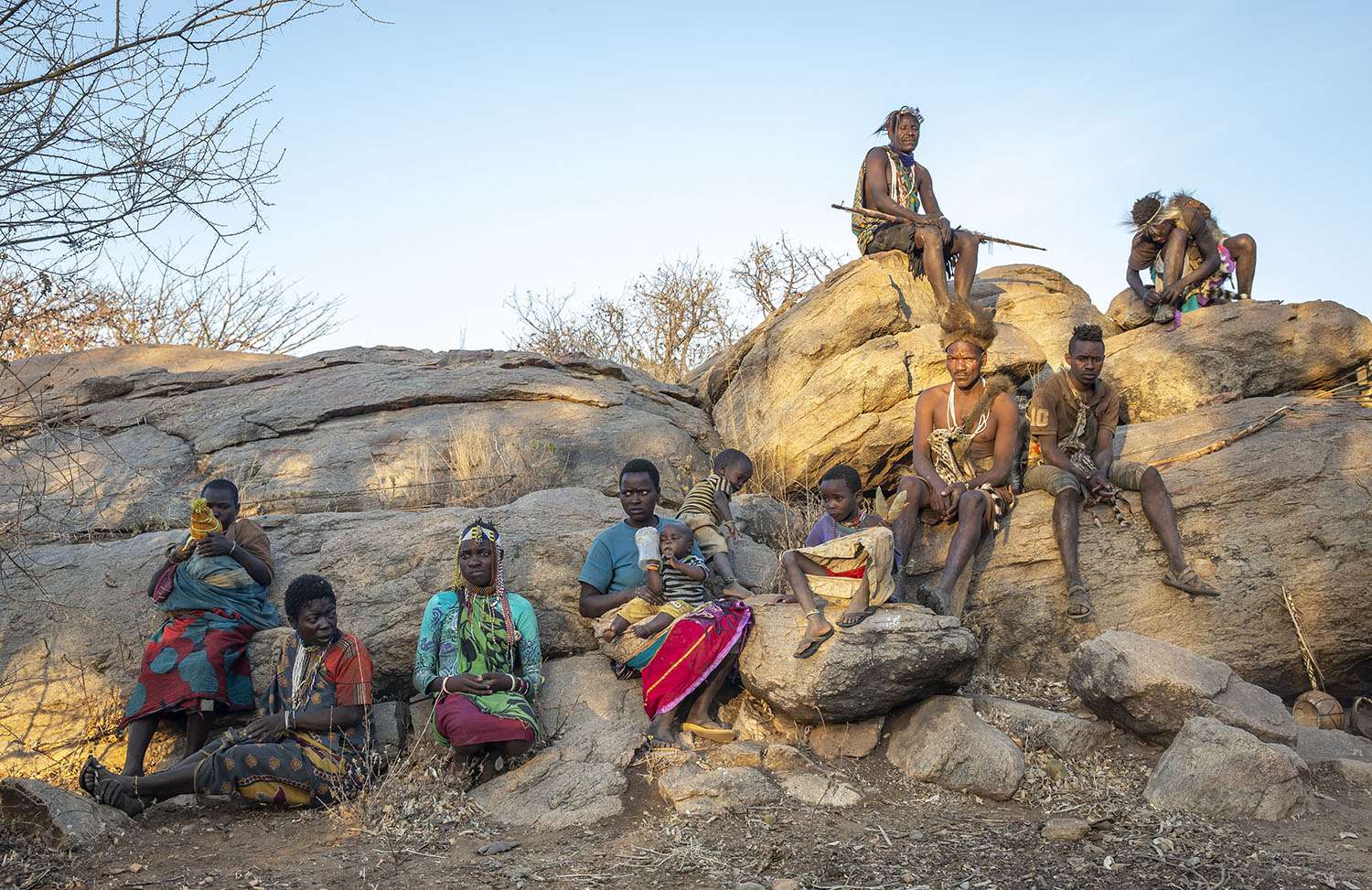 Hadzabe family with resting on a rock