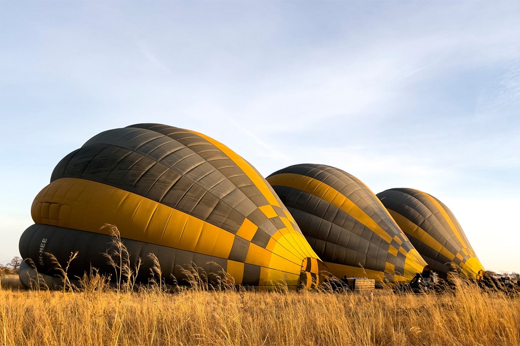 Hot air balloon inflating at tarangire national park, tanzania