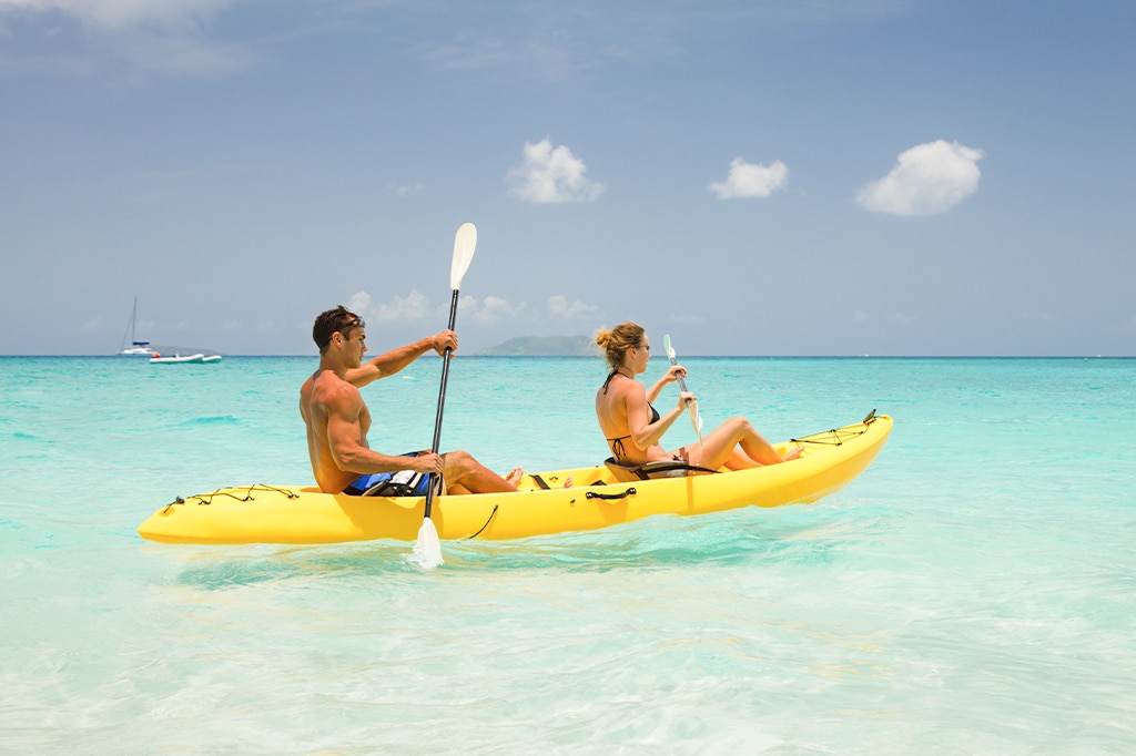 young couple kayaking at Mnemba Island, Tanzania