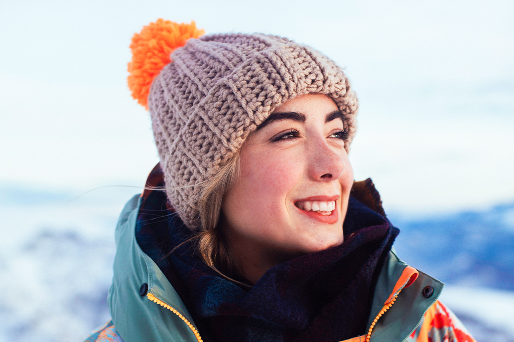 A young woman hiker wearing a knit hat A young woman hiker wearing a knit hat