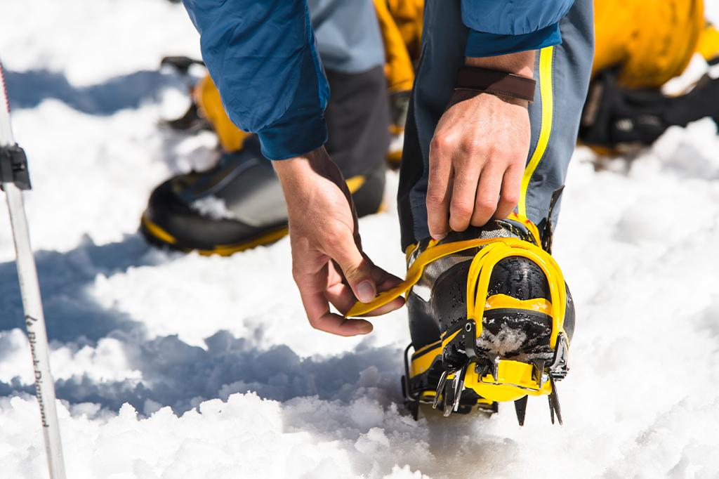Close up of a hiker wearing crampons Close up of a hiker wearing crampons