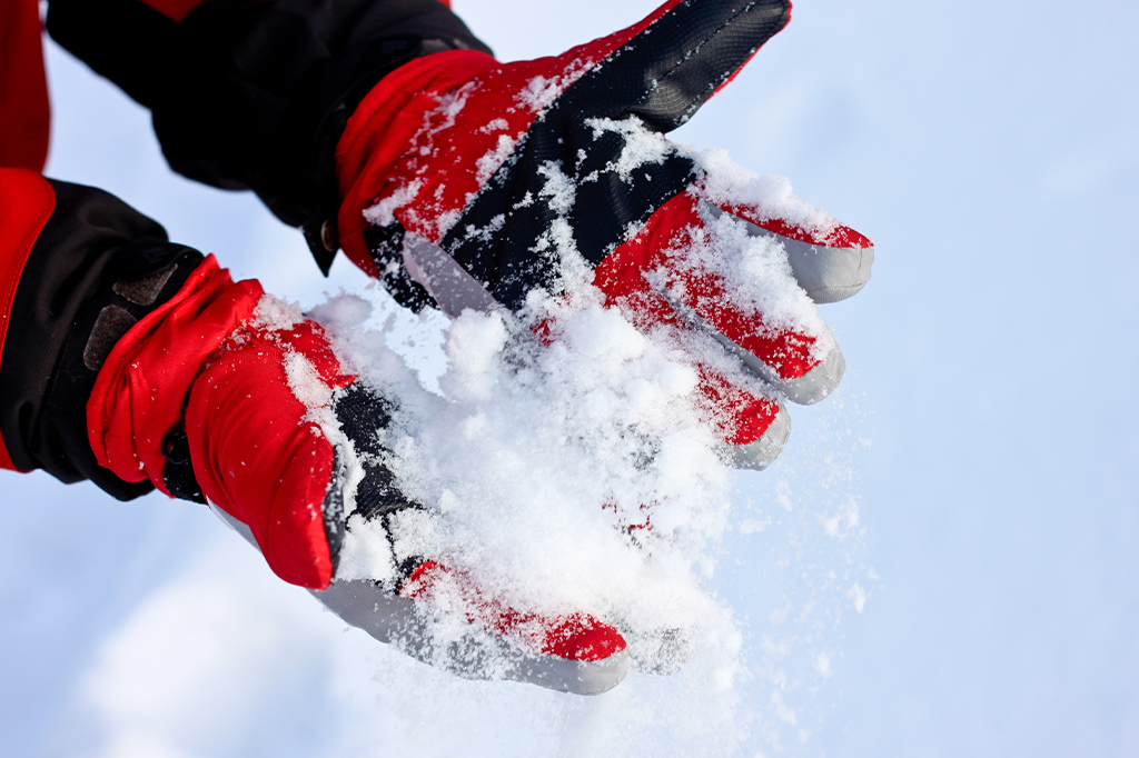 Close up of a hikers hand with winter snow gloves Close up of a hikers hand with winter snow gloves