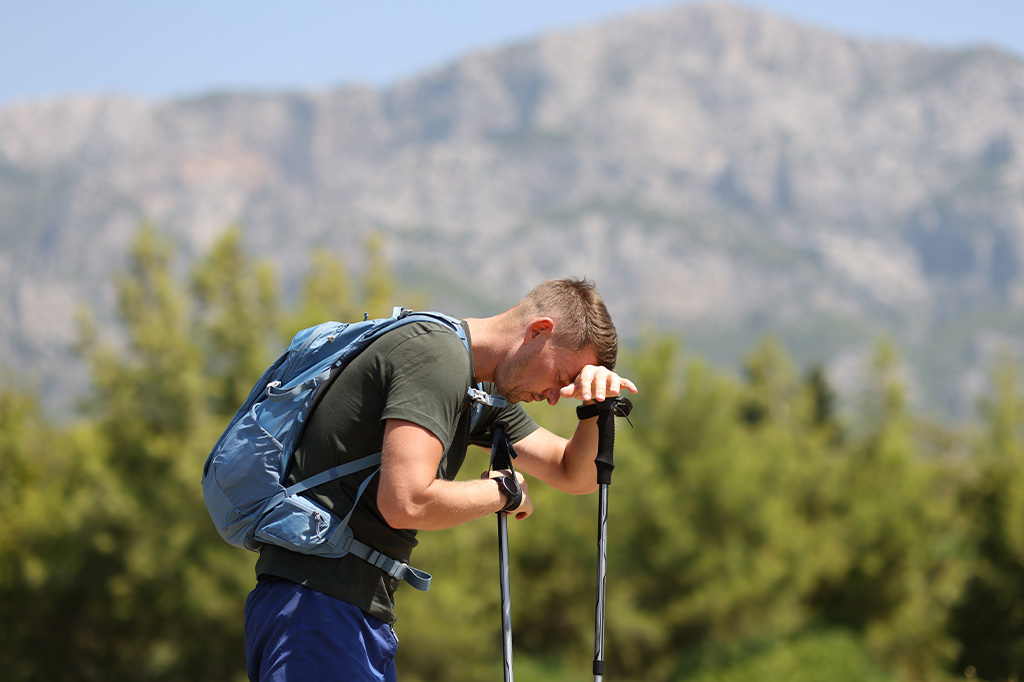 A young hiker suffering from altitude sickness A young hiker suffering from altitude sickness