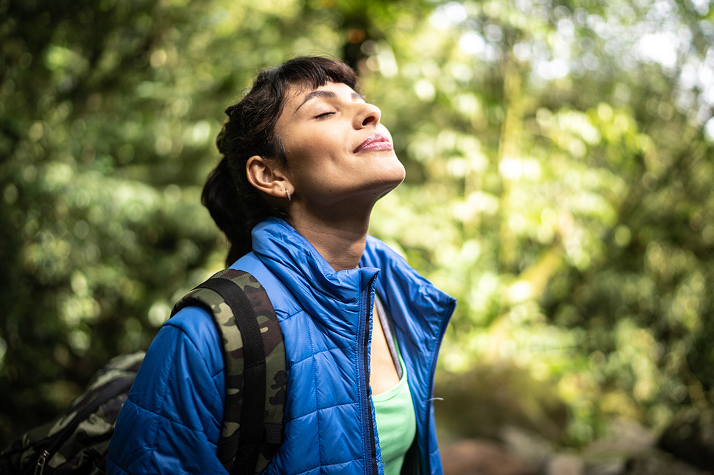 A young woman hiker breathing in the fresh air of Mount Kilimanjaro Tanzania A young woman hiker breathing in the fresh air of mount kilimanjaro, tanzania