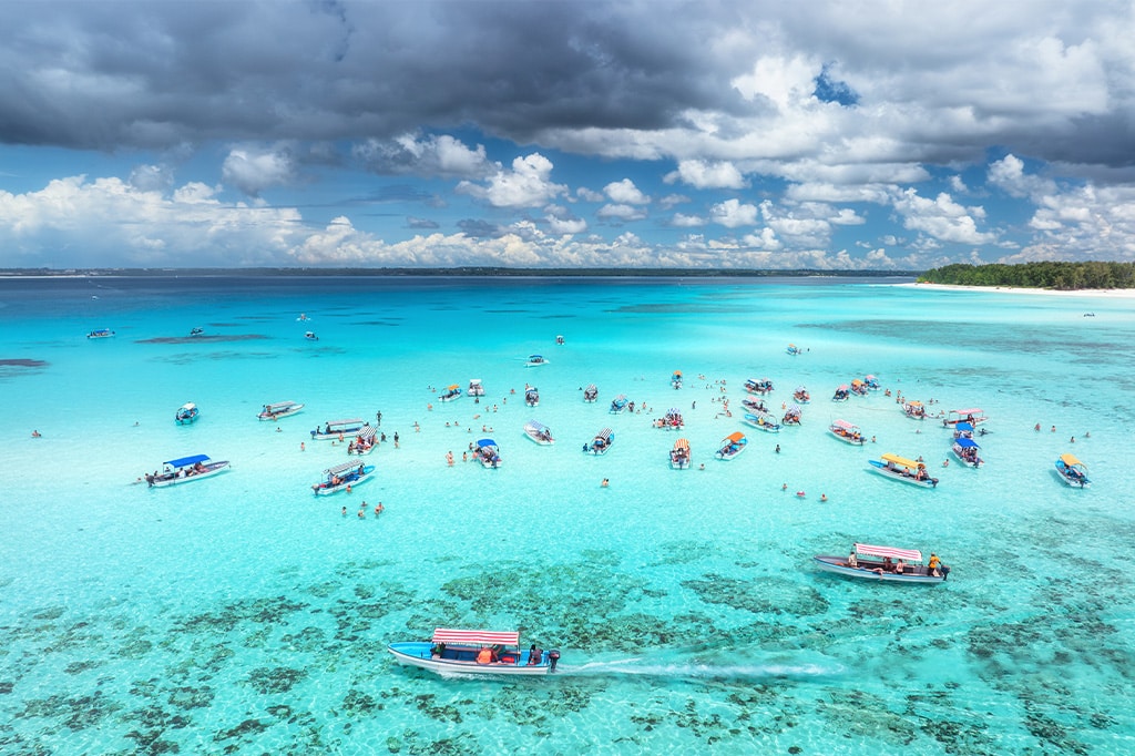 "An aerial view of visitors enjoying the blue waters of Zanzibar just after the rain, Tanzania